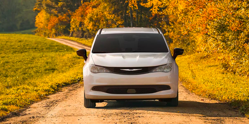 A 2025 Chrysler Voyager driving down an autumn road in Starke, FL 